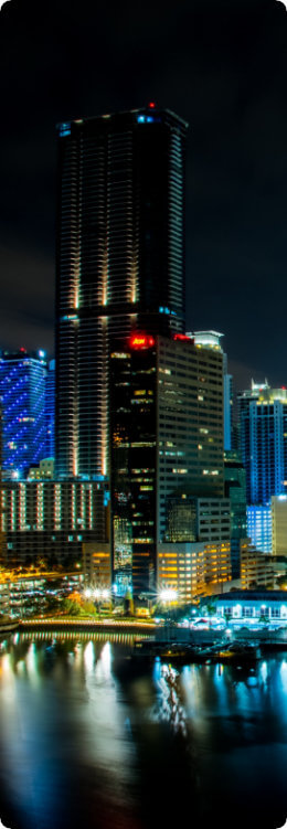 A towering skyscraper illuminated at night